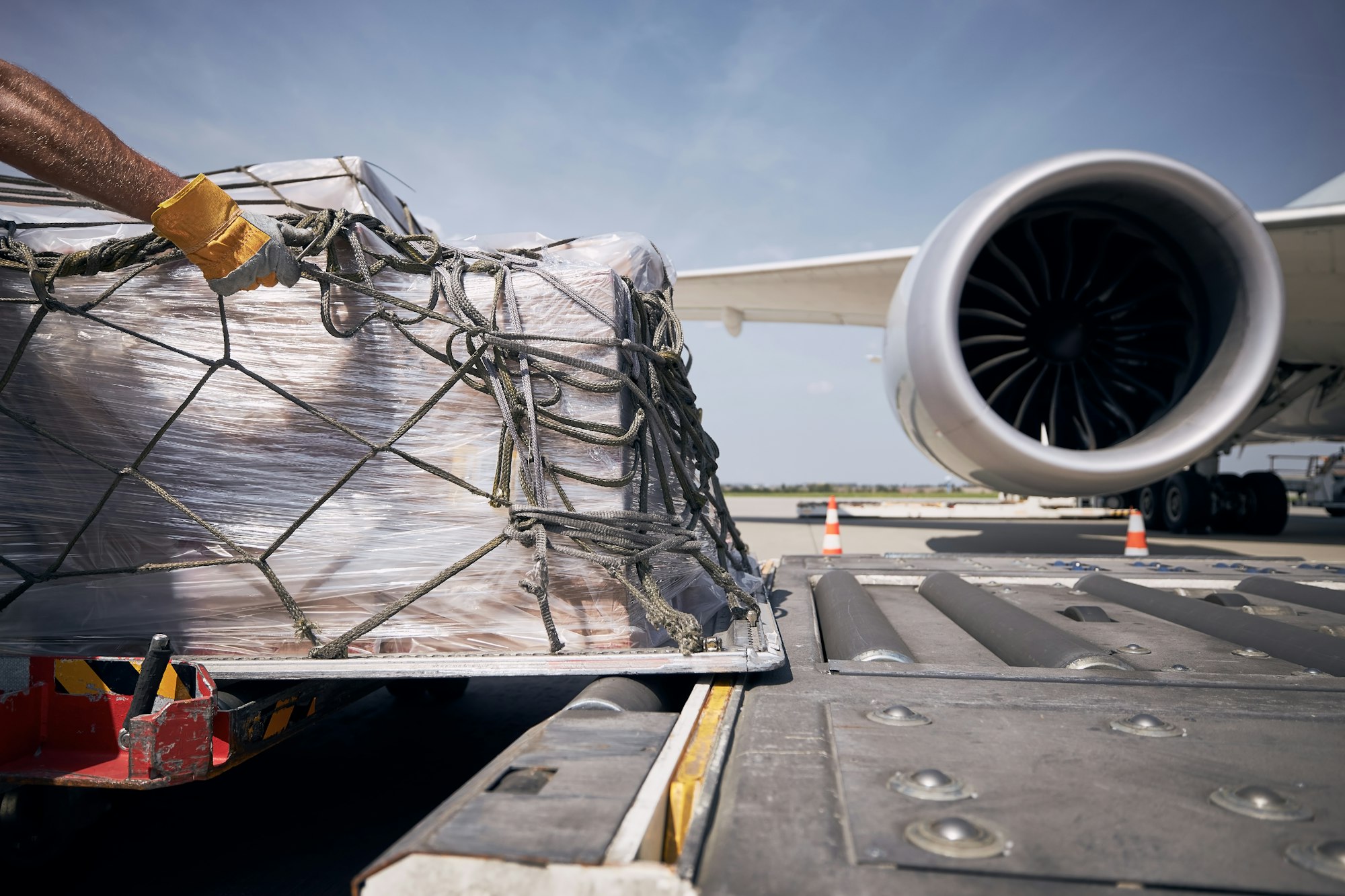 Cargo containers against jet engine of freight airplane